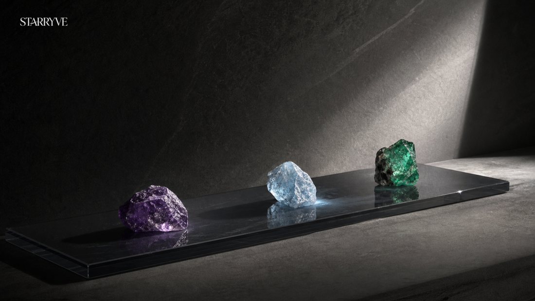 Purple, blue and green gemstones displayed on a black architectural plinth