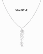Silver flower name necklace with a birth flower charm and cursive name pendant on a fine chain