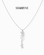 Silver flower name necklace with a birth flower charm and cursive name pendant on a fine chain