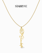 Gold flower name necklace with a birth flower charm and cursive name pendant on a fine chain