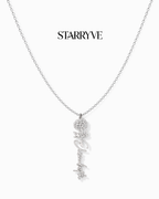 Silver flower name necklace with a birth flower charm and cursive name pendant on a fine chain