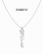 Silver flower name necklace with a birth flower charm and cursive name pendant on a fine chain