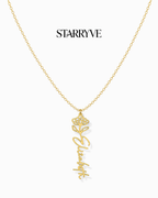 Gold flower name necklace with a birth flower charm and cursive name pendant on a fine chain