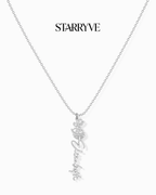 Silver flower name necklace with a birth flower charm and cursive name pendant on a fine chain