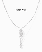 Silver flower name necklace with a birth flower charm and cursive name pendant on a fine chain