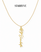 Gold flower name necklace with a birth flower charm and cursive name pendant on a fine chain