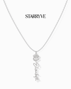 Silver flower name necklace with a birth flower charm and cursive name pendant on a fine chain