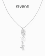 Silver flower name necklace with a birth flower charm and cursive name pendant on a fine chain