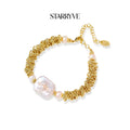 Spiral dreams bracelet with textured gold coils, flat baroque pearl, and blush freshwater pearls