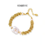 Spiral dreams bracelet with textured gold coils, flat baroque pearl, and blush freshwater pearls