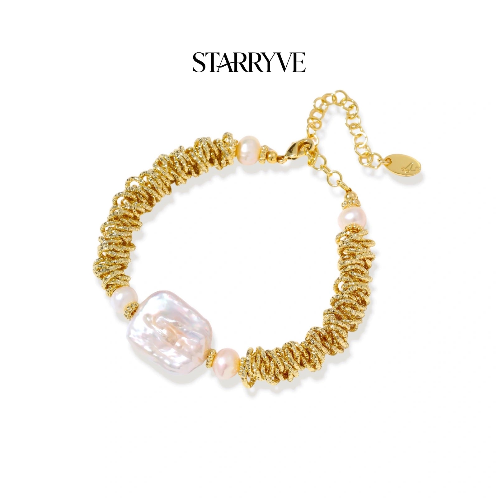 Spiral dreams bracelet with textured gold coils, flat baroque pearl, and blush freshwater pearls