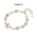 Baroque pearl crystal bracelet with grey gemstone beads and a gold coil-wrapped pearl