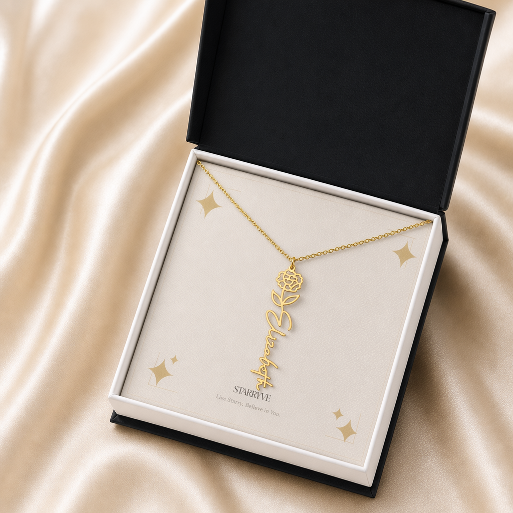 Gold flower name necklace with the January carnation birth flower, shown in a black standard gift box