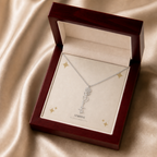 Silver flower name necklace with the January carnation birth flower, shown in a mahogany LED luxury gift box