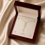 Gold flower name necklace with the October marigold birth flower, shown in a mahogany LED luxury gift box
