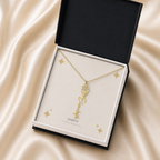 Gold flower name necklace with the December narcissus birth flower, shown in a black standard gift box