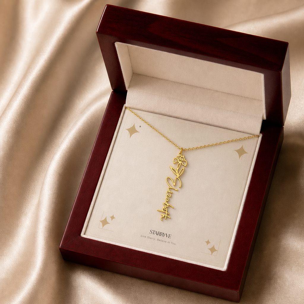 Gold flower name necklace with the February iris birth flower, shown in a mahogany LED luxury gift box