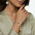 Woman wearing the baroque pearl crystal bracelet with a green sweater