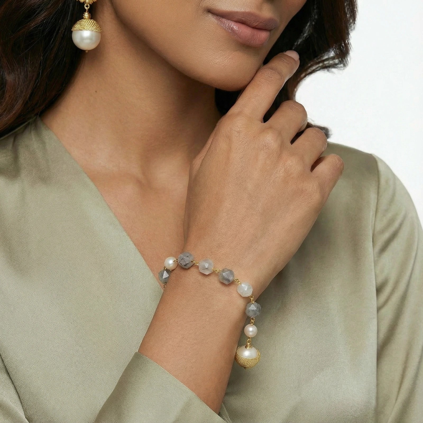 Woman wearing the baroque pearl crystal bracelet with a green sweater
