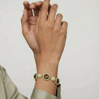 Two women wearing the tiger's eye pearl wisdom bracelet
