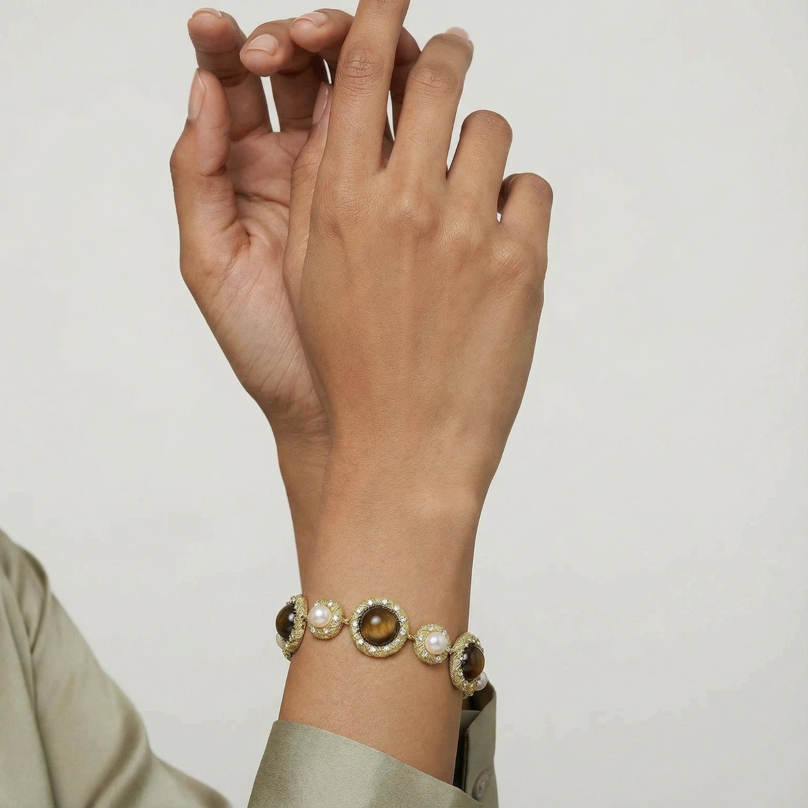 Two women wearing the tiger's eye pearl wisdom bracelet