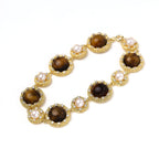 Detail view of crystal-framed tiger's eye and pearl medallion