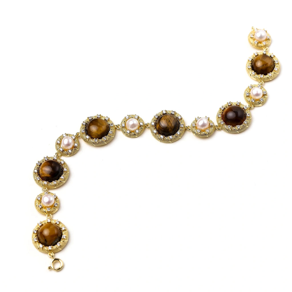 Flat lay of the tiger's eye pearl bracelet showing gold medallion links