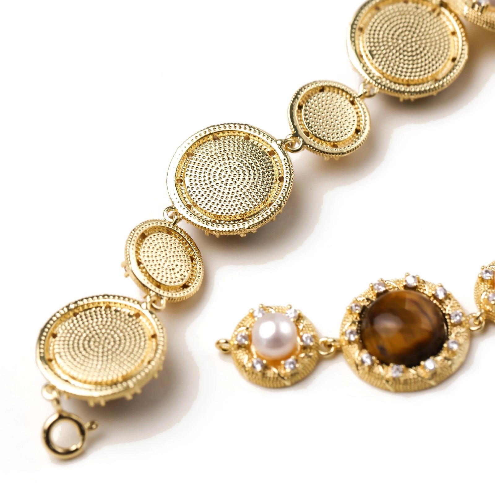 Close-up of the tiger's eye pearl wisdom bracelet on a wrist
