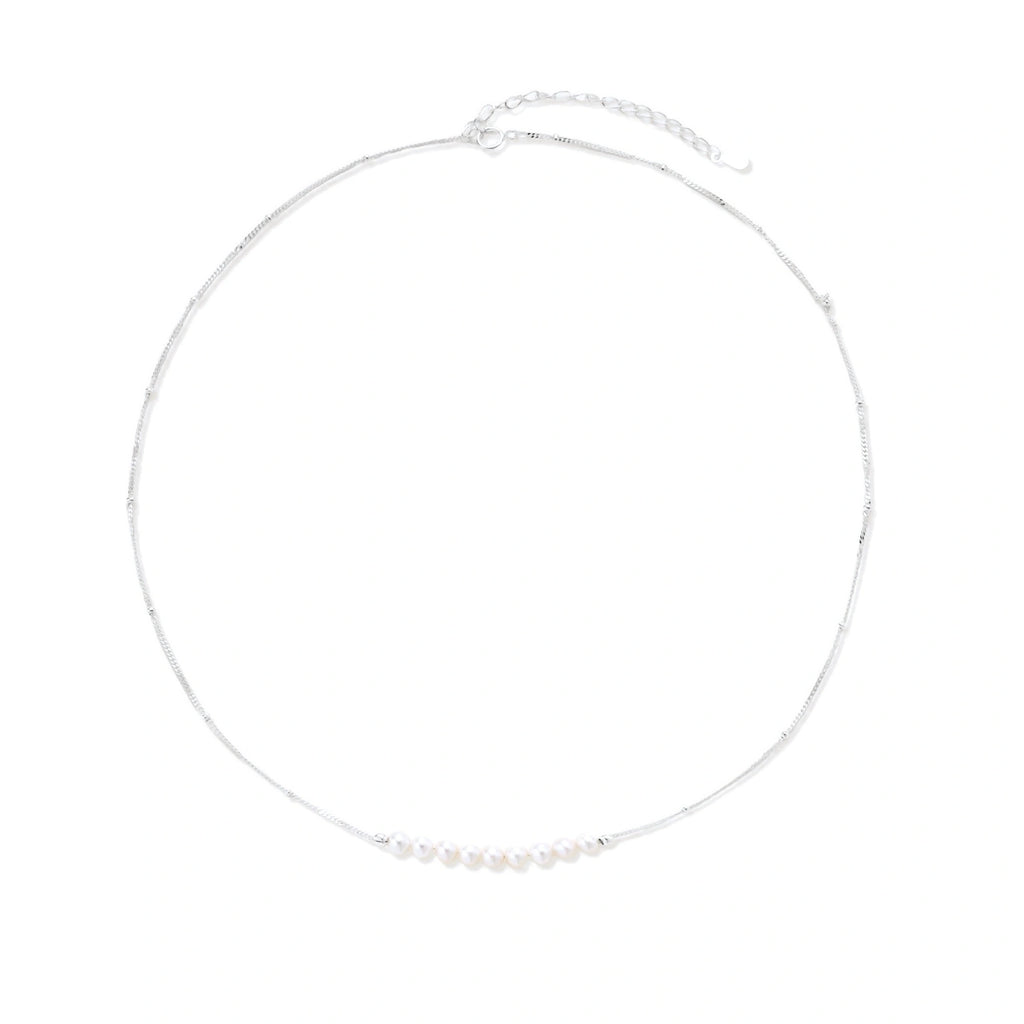 Model wearing Luna Pearl Arc Necklace