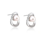 Model wearing Pearl Orbit Studs