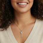 Woman wearing the secret heart key necklace with a dark blazer