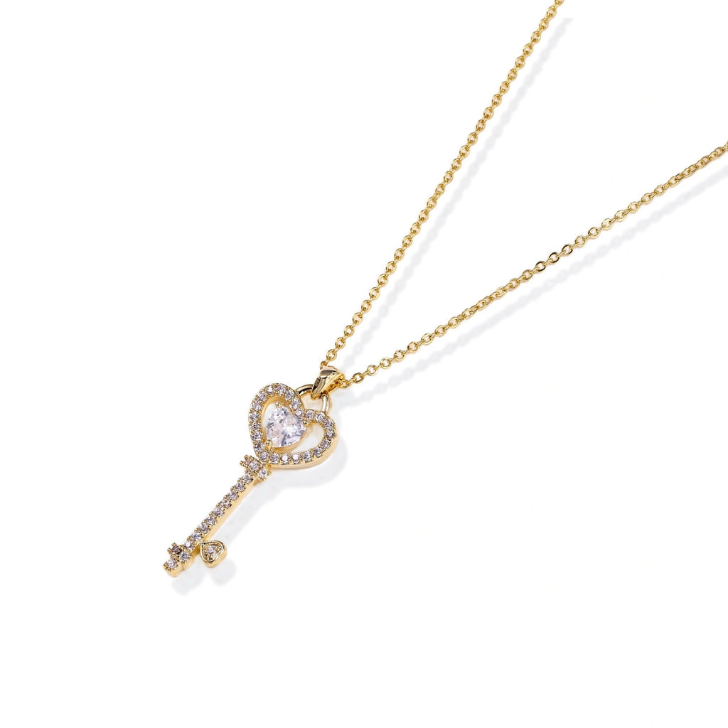 Close-up of the crystal pavé heart key pendant at the neckline