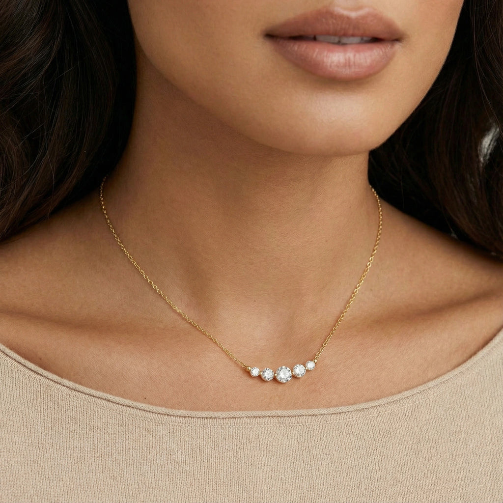 Close-up of the five-stone cubic zirconia arc necklace at the neckline