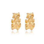 Model wearing Wave Flow Hoop Earrings - Gold Ruffled Texture