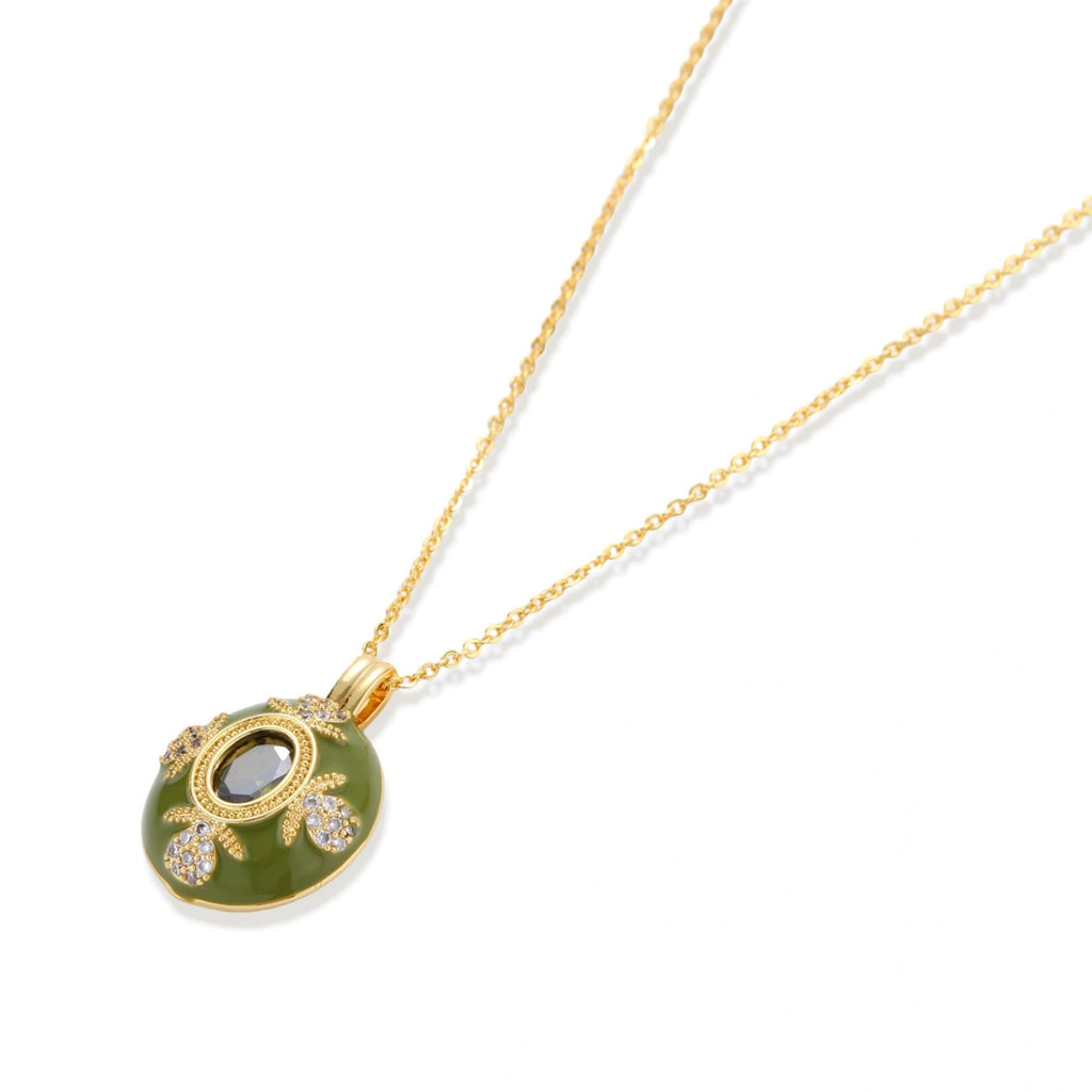 Flat lay of the emerald empress pendant on a white background