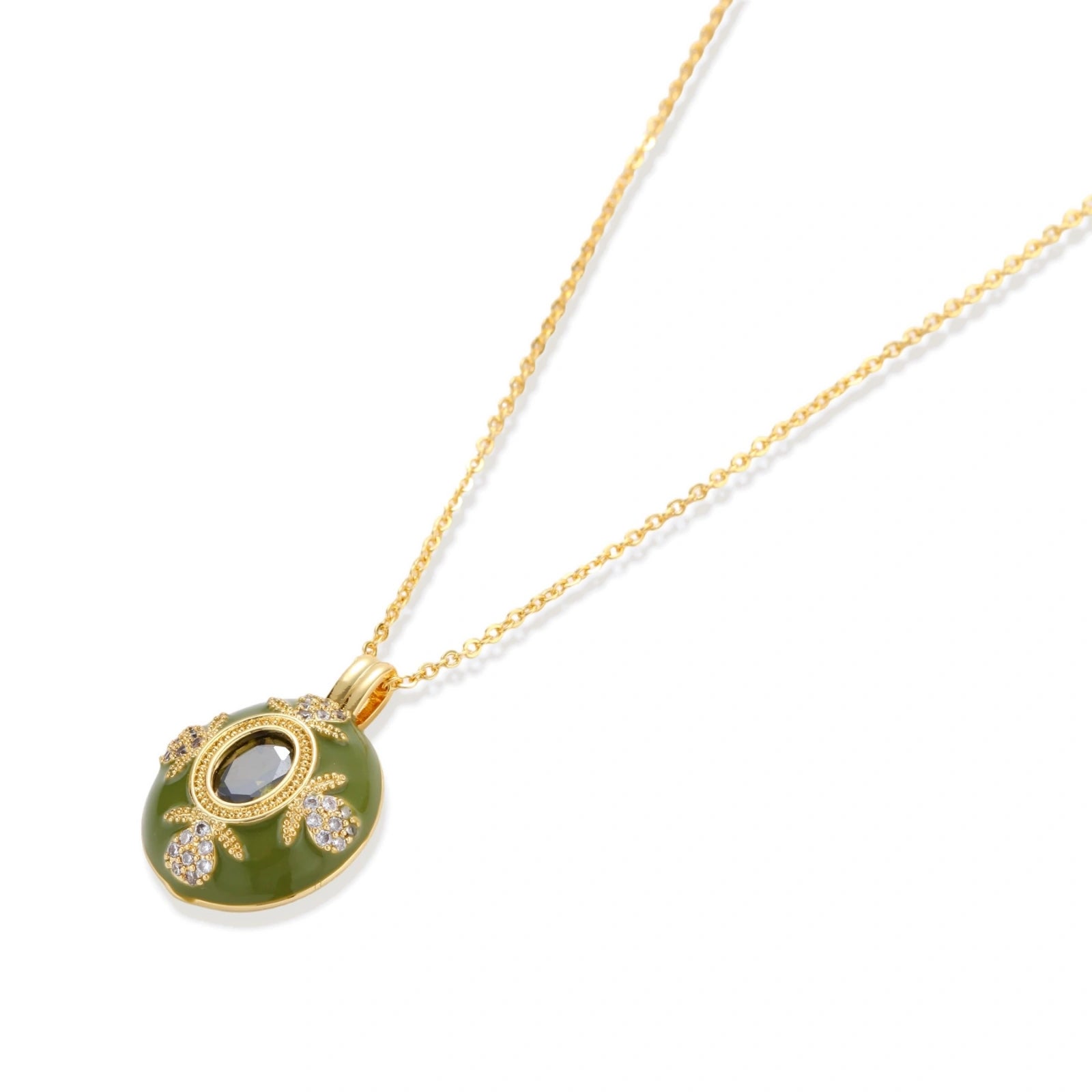 Flat lay of the emerald empress pendant on a white background