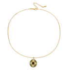 Minimalist view of the emerald empress pendant on a fine gold chain