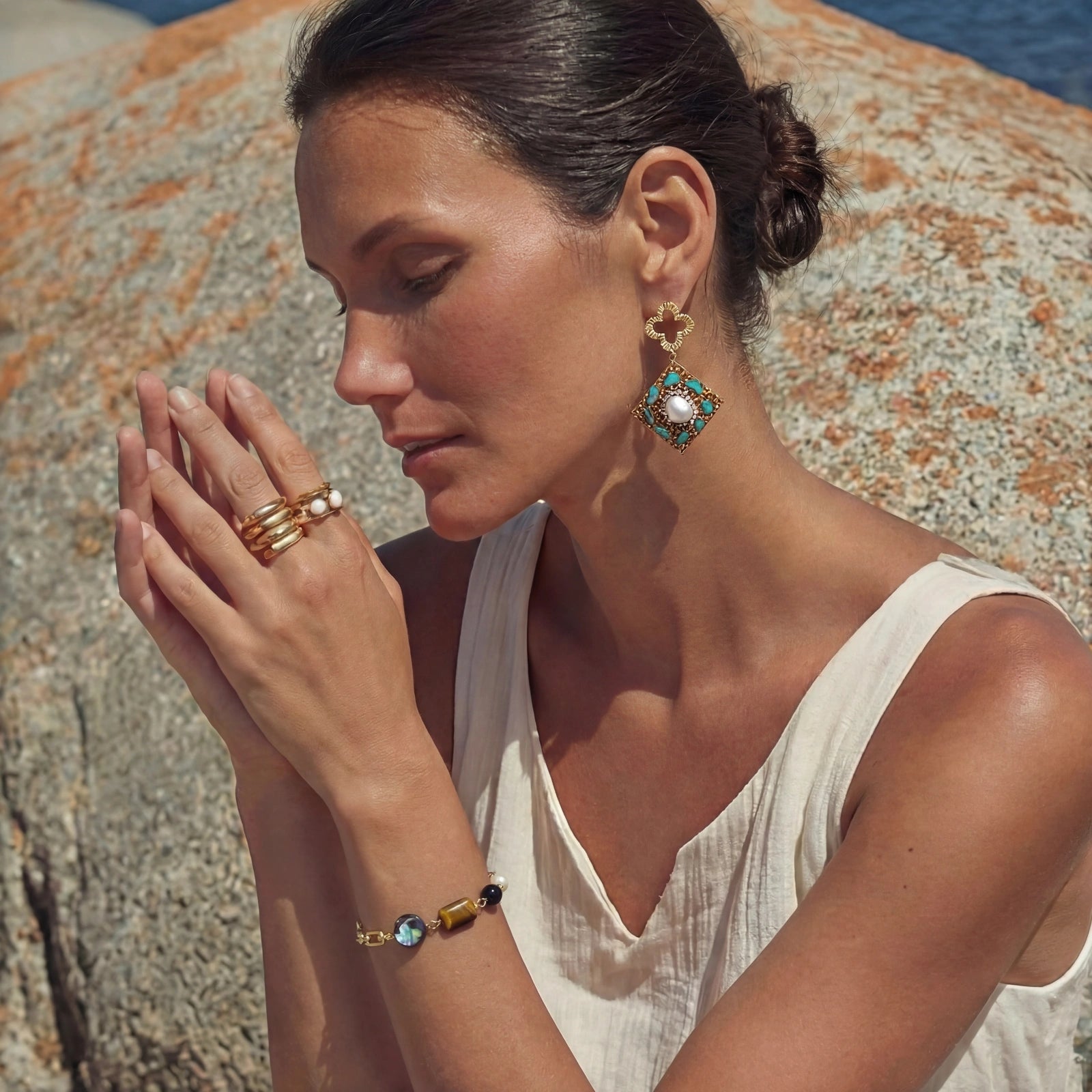 Woman wearing the earth elements bracelet stacked with other bracelets