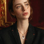 Woman wearing the mystic pearl pendant necklace with a dark blazer