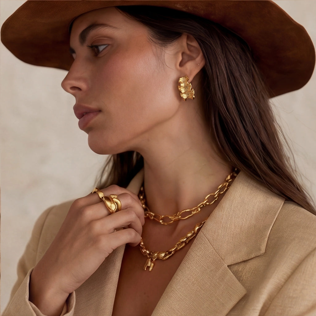 Model wearing Wave Flow Hoop Earrings - Gold Ruffled Texture