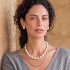 Woman wearing the golden pearl layers necklace outdoors