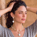 Woman wearing the lumina pearl station necklace, portrait view