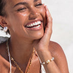 Woman wearing the baroque pearl crystal bracelet, smiling