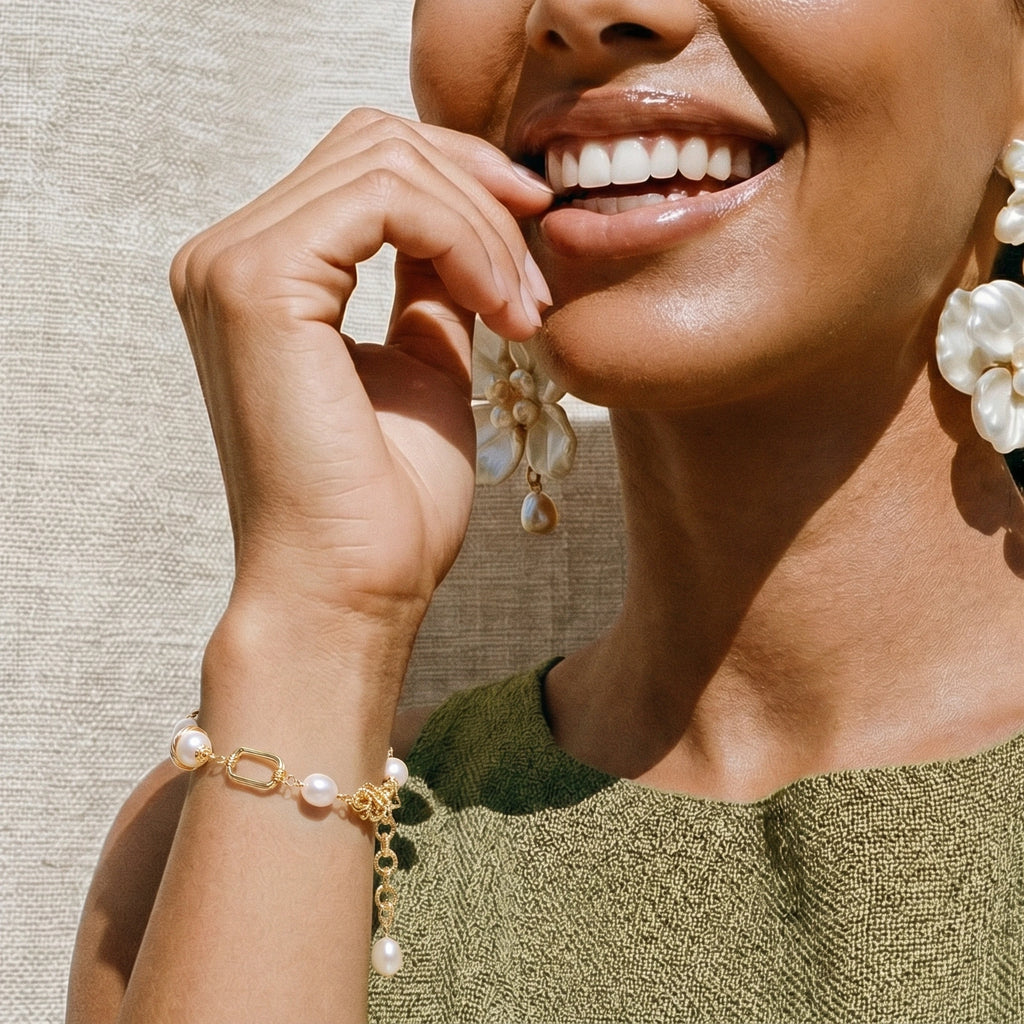 Woman wearing the golden pearl chain bracelet on her wrist