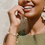 Woman wearing the golden pearl chain bracelet on her wrist