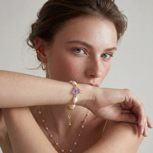 Close-up of the amethyst and baroque pearl bracelet on the wrist