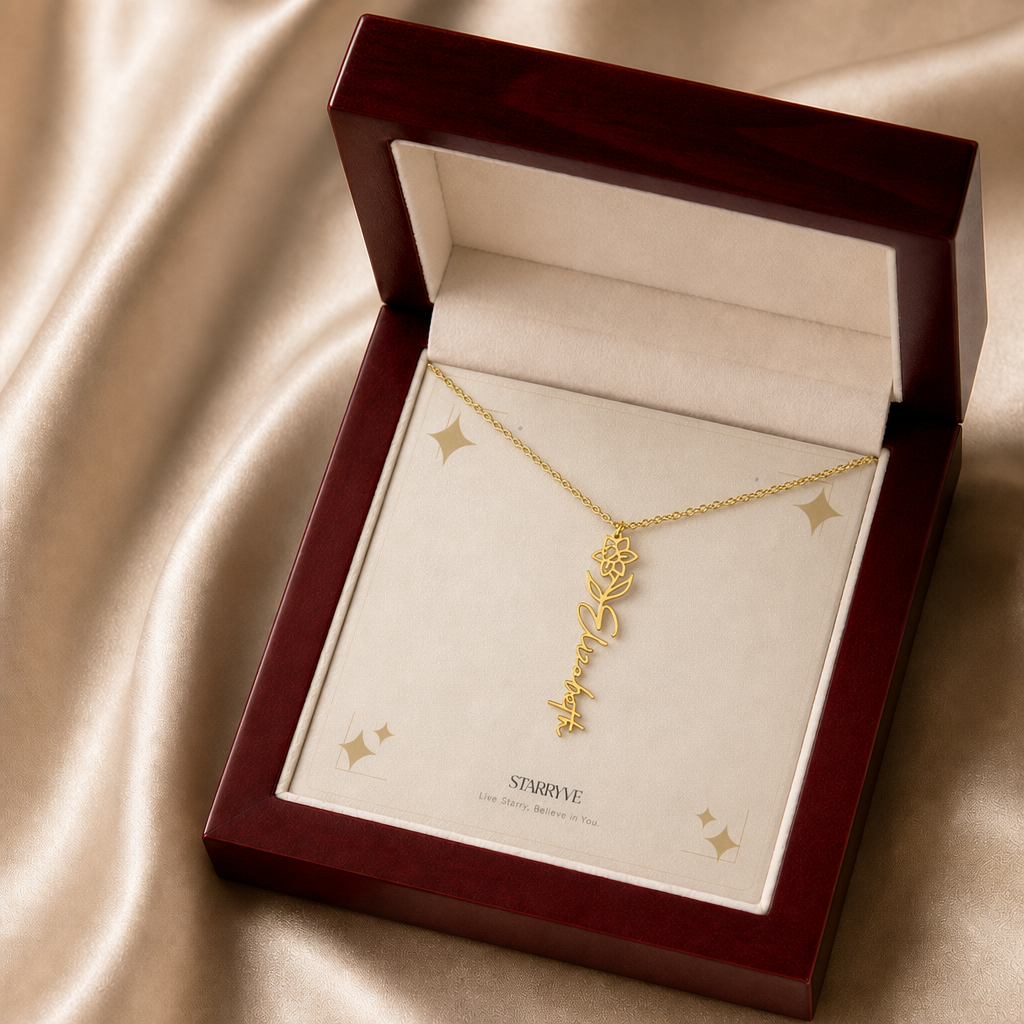 Gold flower name necklace with the March daffodil birth flower, shown in a mahogany LED luxury gift box