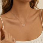 Woman wearing the two-tone interlocking hearts necklace