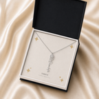 Silver flower name necklace with the April daisy birth flower, shown in a black standard gift box