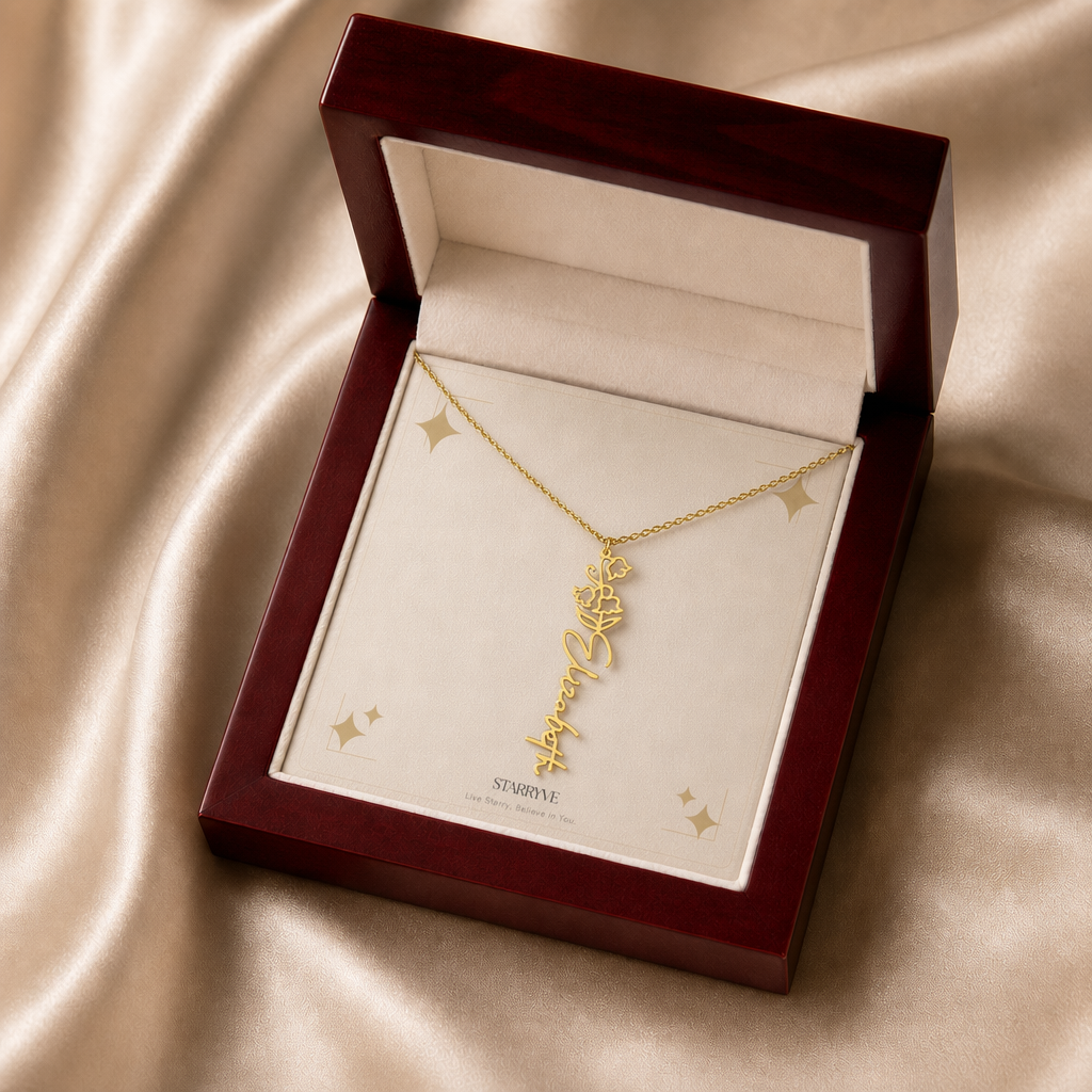 Gold flower name necklace with the May lily of the valley birth flower, shown in a mahogany LED luxury gift box